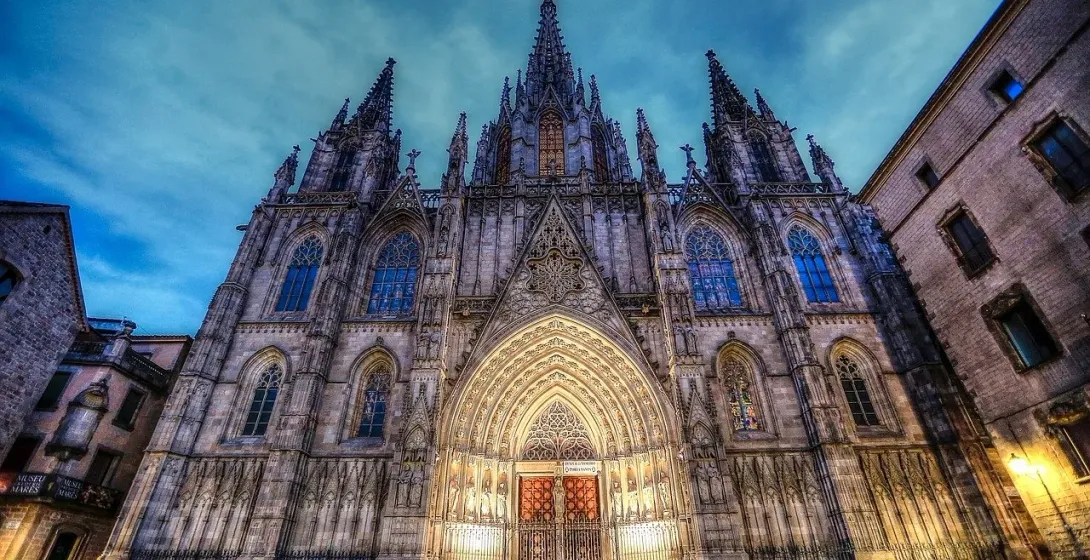 Barcelona Cathedral at dusk, tourists admiring the Gothic architecture.