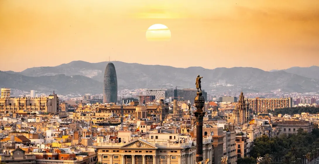 Barcelona sunset: Stunning cityscape with Columbus Monument and Torre Agbar.