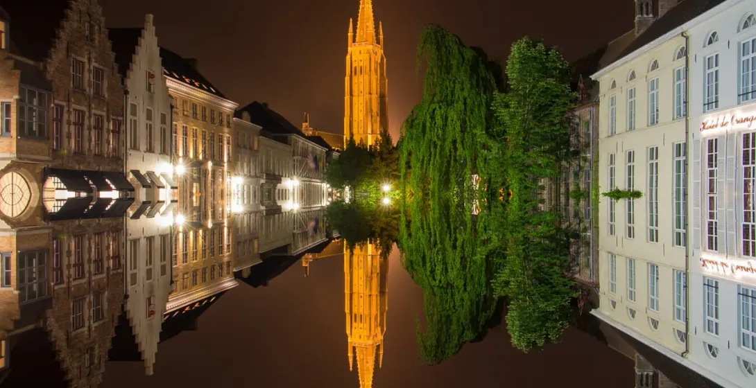 Bruges by Night: Stunning reflection of the Belfry and canals.