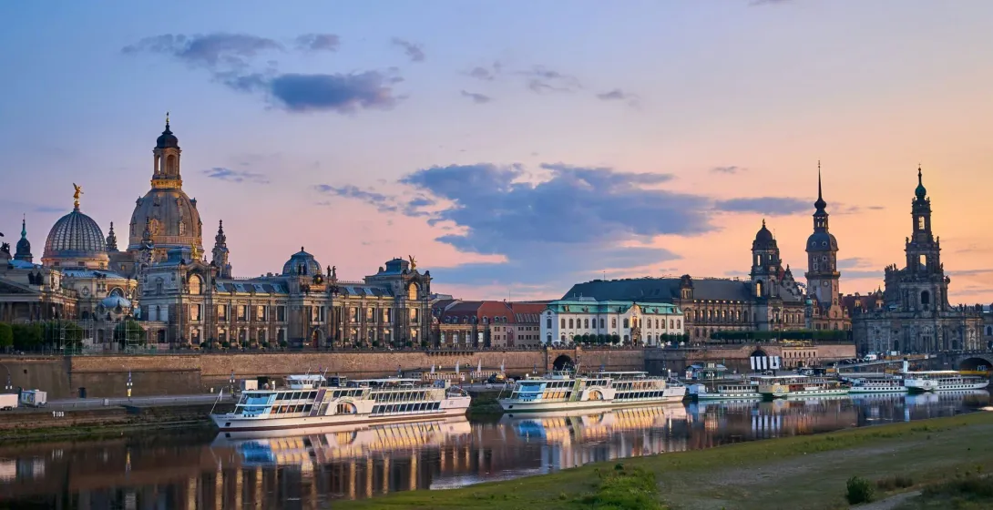 Dresden skyline at sunset, reflecting in the Elbe River.