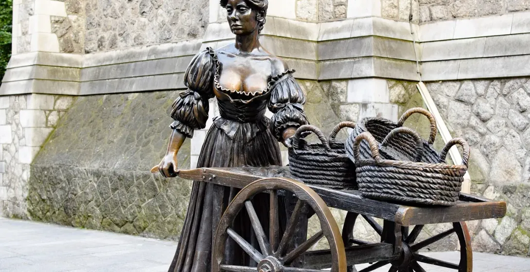 Bronze statue of a woman with a cart in Dublin, Ireland.
