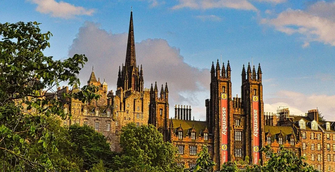 Historic Edinburgh skyline featuring the Assembly Rooms and a church spire.