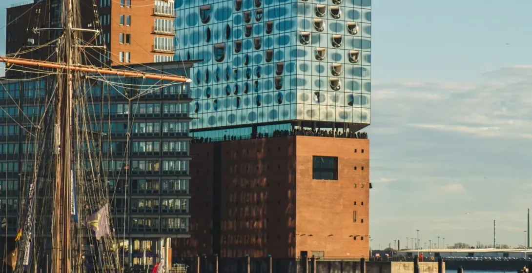 The Elbphilharmonie in Hamburg, Germany, with a sailing ship in the foreground.