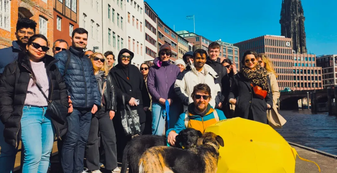 Happy tour group in Hamburg, Germany, enjoying a city tour along the canal.