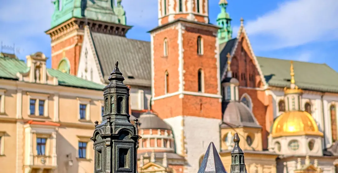 Bronze model of Wawel Cathedral in Krakow, Poland, with the real cathedral blurred in the background.