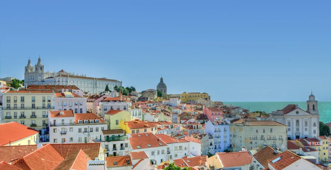 Panoramic view of Lisbon's terracotta rooftops and historical buildings.