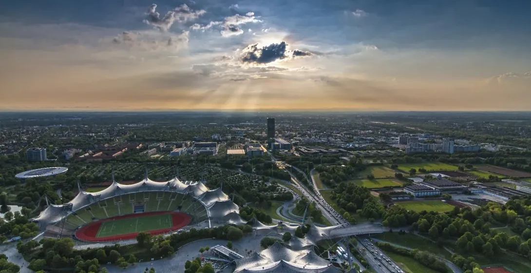 Aerial view of Munich's Olympic Stadium at sunset.