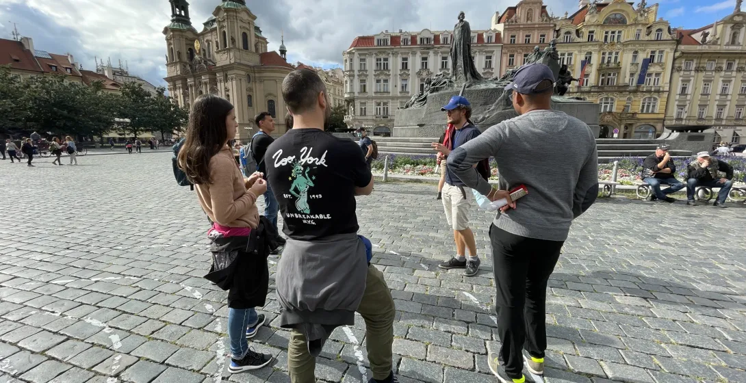 A guided tour group in Prague's Old Town Square.