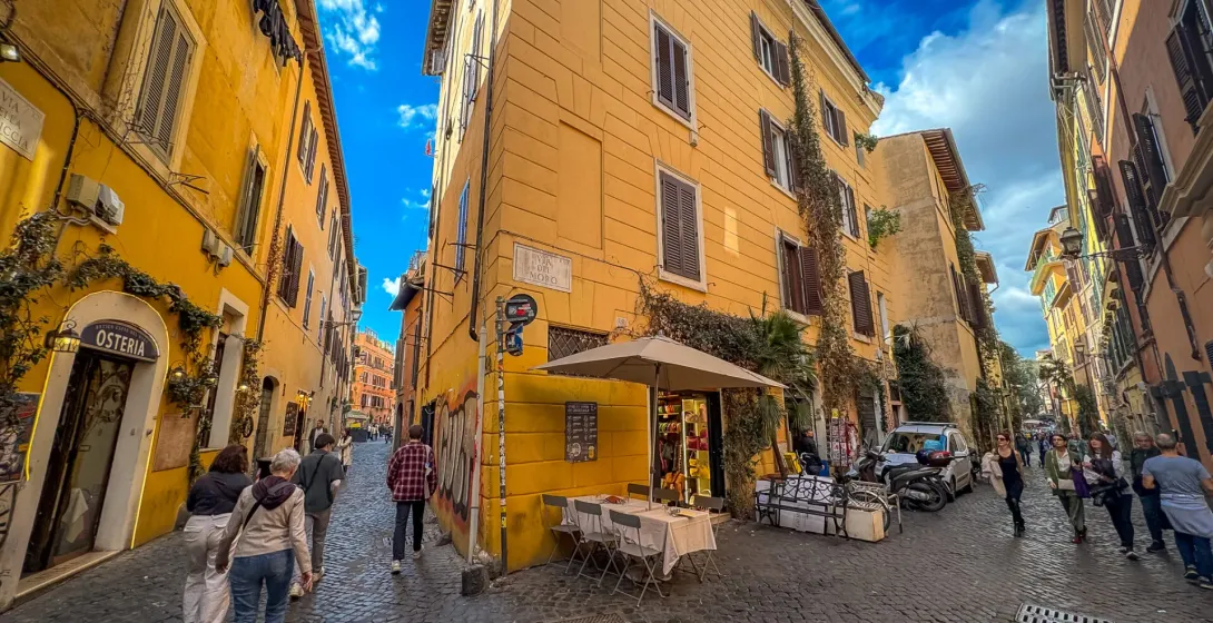 Tourists exploring the charming cobblestone streets of Trastevere, Rome.