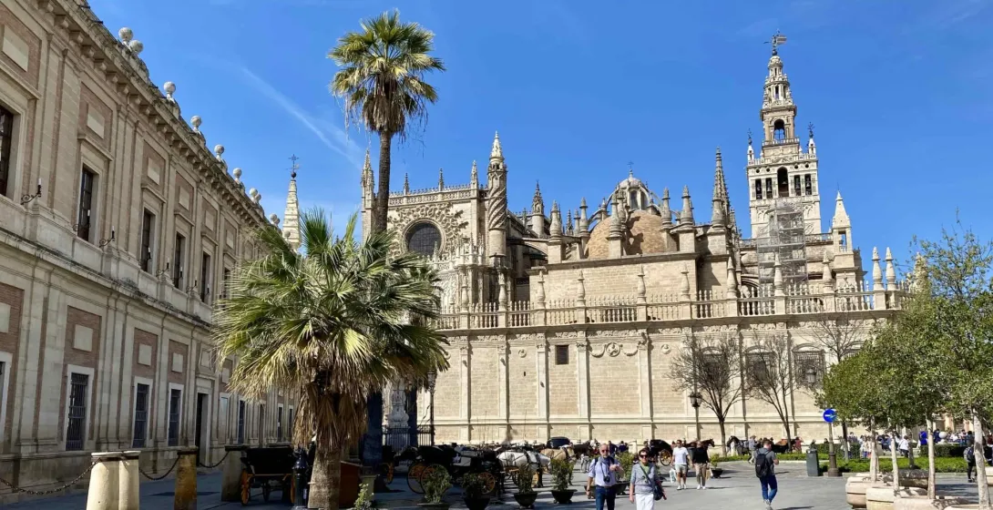 Tourists exploring the magnificent Seville Cathedral in Spain.