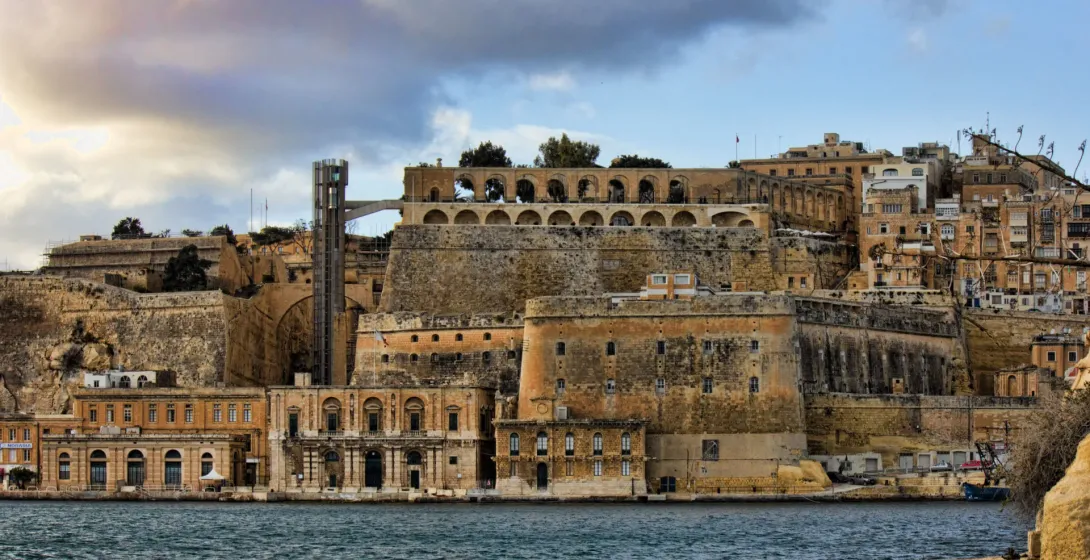Historic Valletta waterfront in Malta, showcasing ancient fortifications and buildings.
