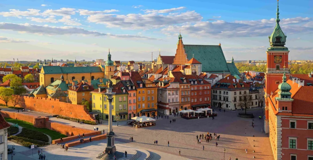 Panoramic view of Warsaw's Old Town Square at sunset.