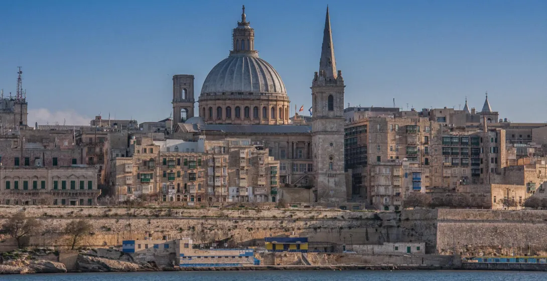 Valletta skyline from the sea, showing the dome of Our Lady of Mount Carmel Basilica, St Paul's Pro-Cathedral spire, and hist