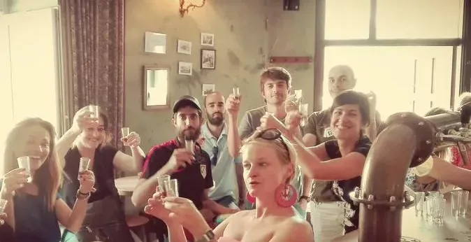 Tour group toasting with glasses.