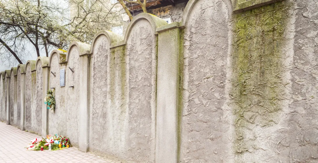 Remuh Cemetery wall in Krakow with flowers and candles.