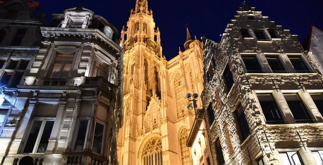 Antwerp's Our Lady's Cathedral illuminated at night during a Dark Stories tour.