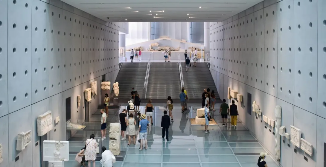 Visitors exploring ancient artifacts at the Acropolis Museum in Athens.