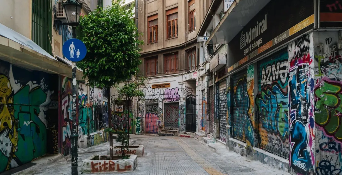 Colorful graffiti art adorns the walls of a narrow alleyway in Athens, Greece.