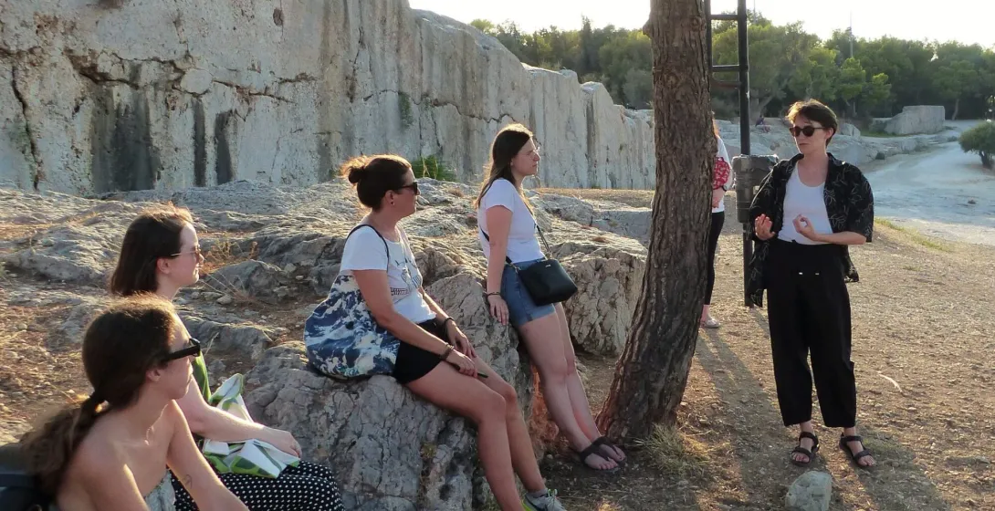 A guided tour group explores ancient ruins in Athens, Greece.
