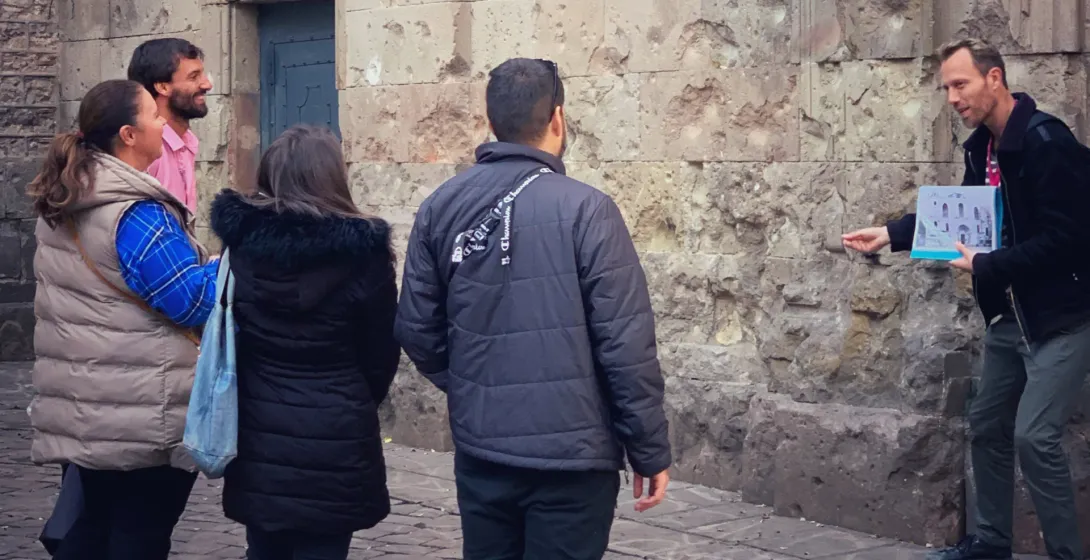 A tour guide leads a small group on a walking tour in Barcelona, Spain.