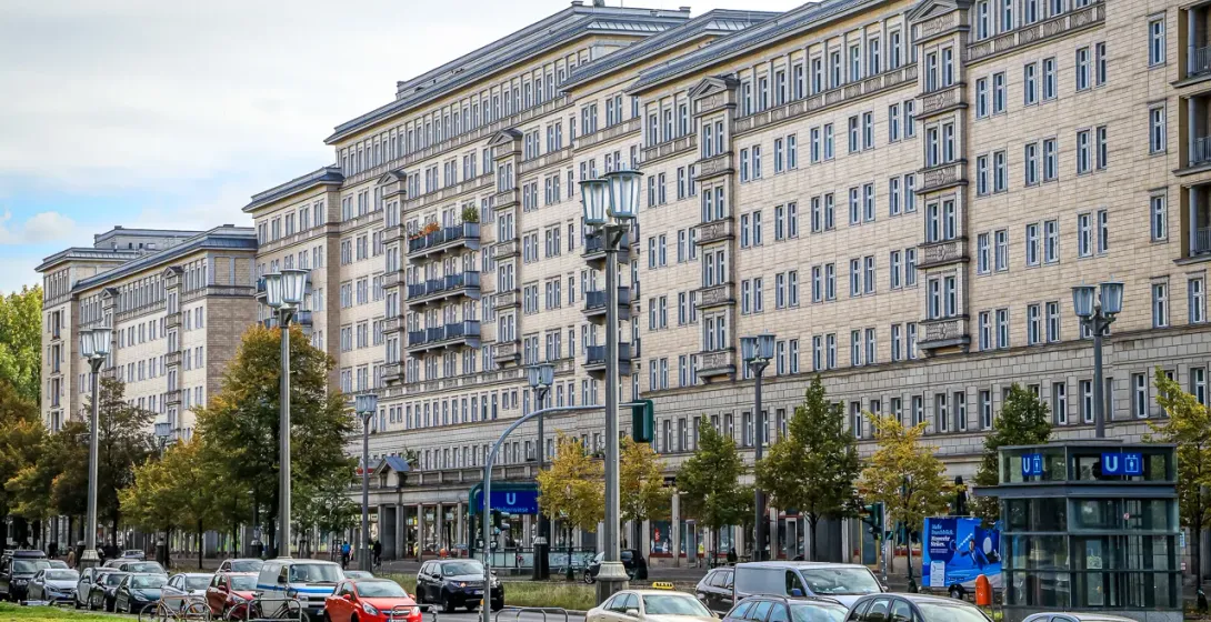 Classic Berlin apartment buildings line a city street.