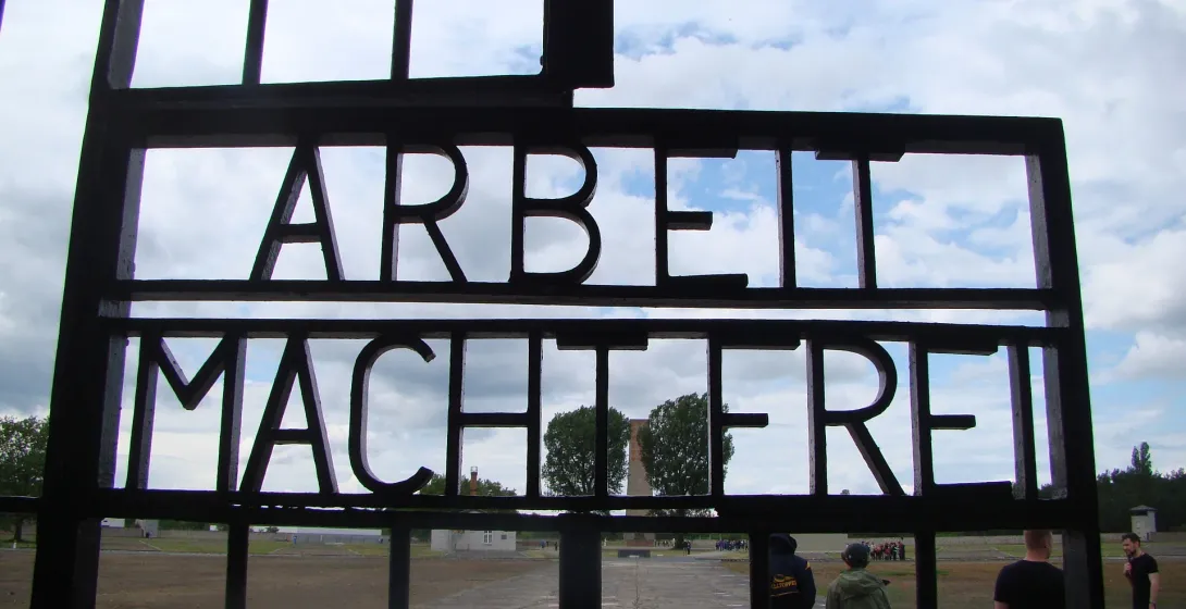 Tourists visiting the Sachsenhausen Concentration Camp gate in Berlin, Germany.