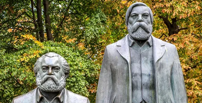 Bronze statues of Karl Marx and Friedrich Engels in a Berlin park.