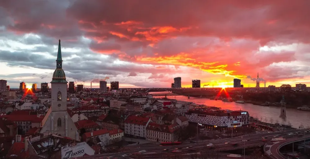Stunning sunset over Bratislava, Slovakia, showcasing the city's skyline and St. Martin's Cathedral.