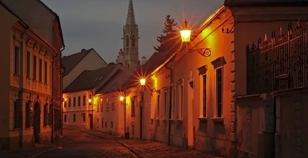Spooky Bratislava tour: A charming cobblestone street at night.