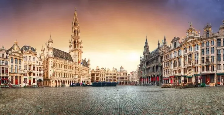 Sunrise view of Brussels' Grand Place, showcasing its stunning architecture.