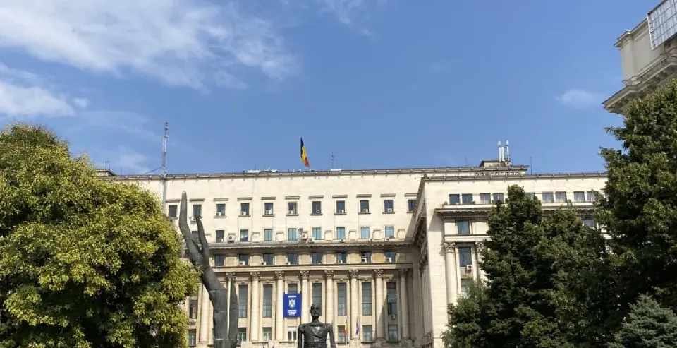 The Palace of the Parliament in Bucharest, Romania, with sculptures in the foreground.