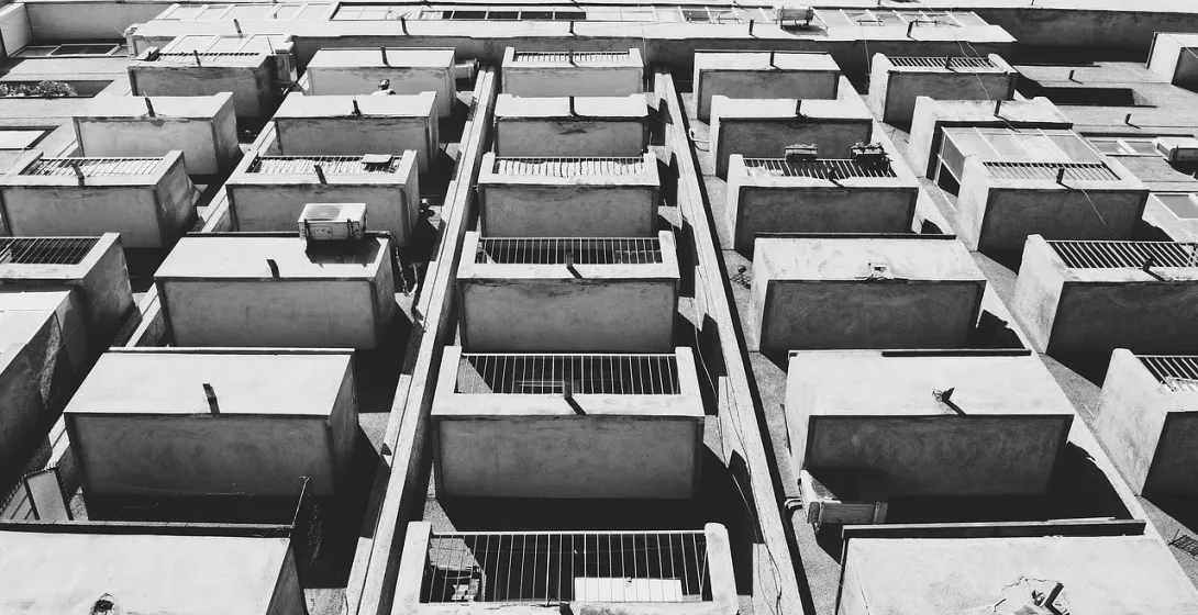Black and white photo of a Bucharest apartment building, showcasing its unique architecture.