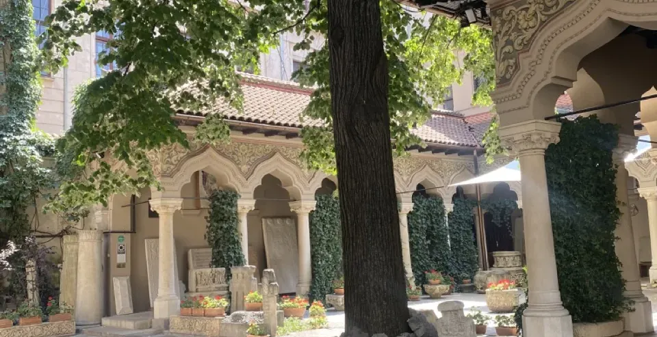 Tranquil courtyard of a historic Romanian monastery in Bucharest.