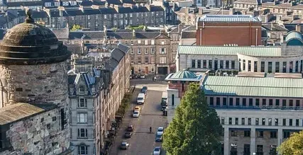 Panoramic view of Edinburgh, Scotland, showcasing historic and modern architecture.