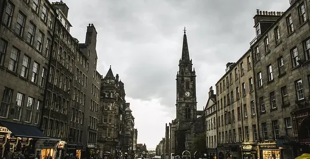 Tourists exploring a historic street in Edinburgh, Scotland.