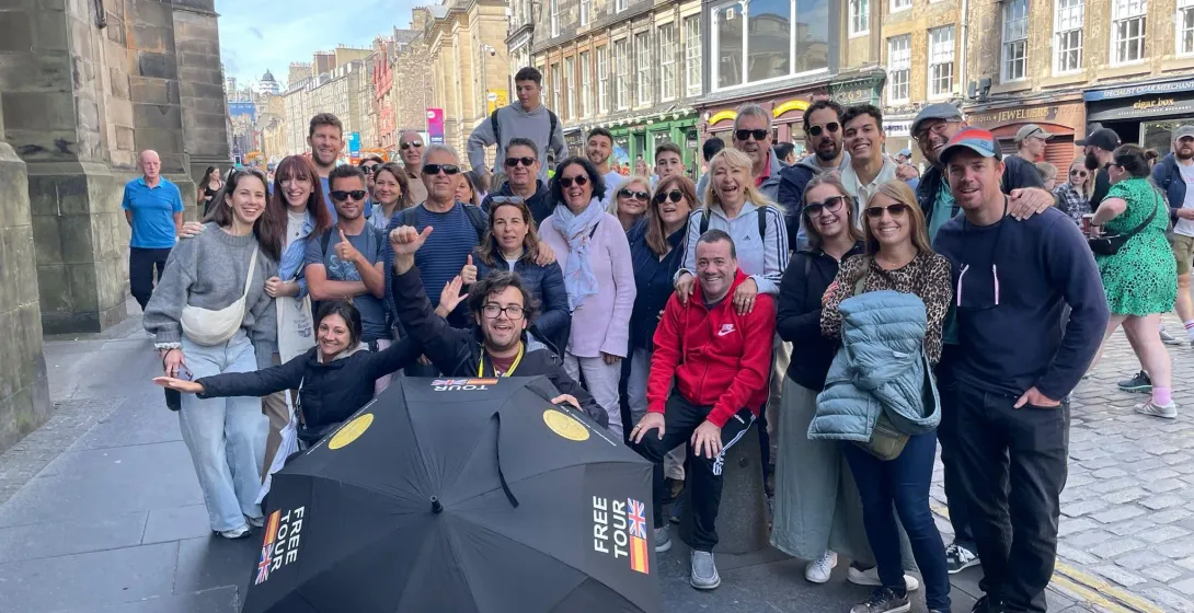 Happy tourists on a free walking tour in Edinburgh, Scotland.