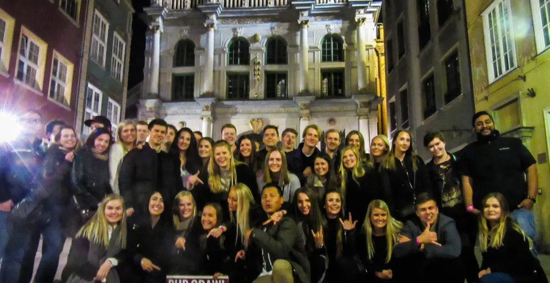 Happy tourists on a Gdańsk pub crawl.