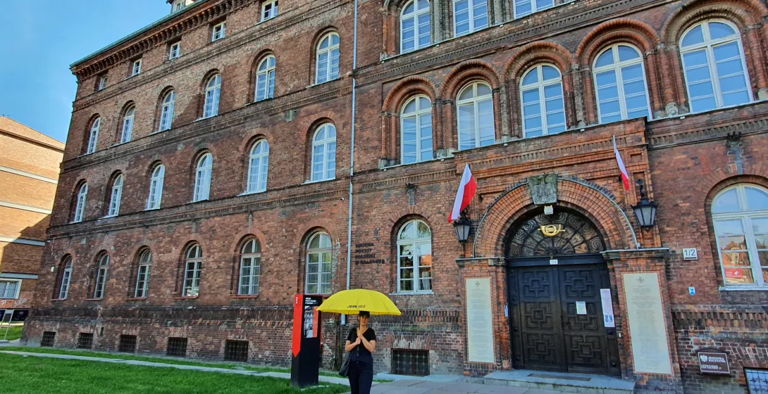 Tourist exploring a historical brick building in Gdansk, Poland.