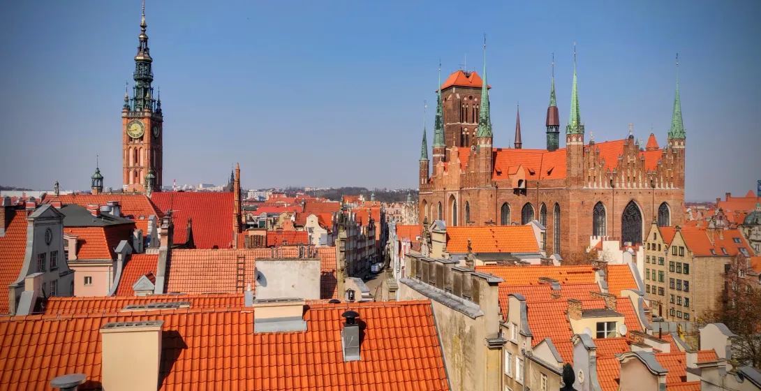Panoramic view of Gdansk's Old Town, featuring St. Mary's Church and the Town Hall.