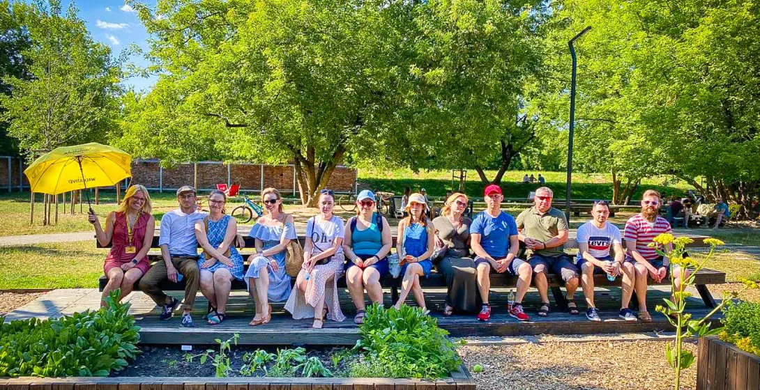 Happy tour group enjoying a sunny day in a German park.