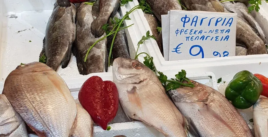 Fresh fish on display at a vibrant Greek market.