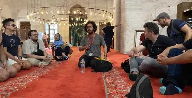 Guided tour group in a historical Istanbul mosque.