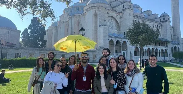 Happy tour group in front of the Süleymaniye Mosque in Istanbul.