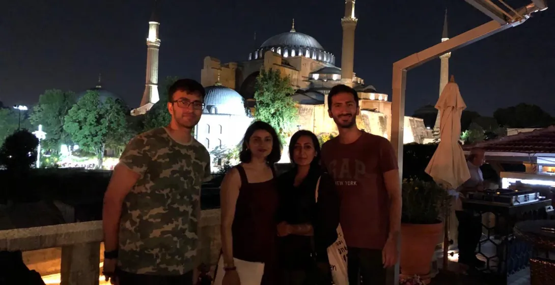 Tourists enjoying a night view of the Hagia Sophia in Istanbul.