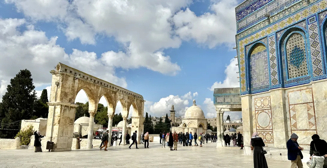 Tourists exploring the Temple Mount in Jerusalem, with the Dome of the Rock visible.