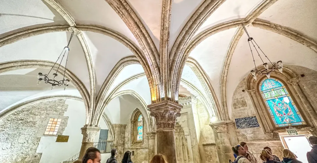Tour group exploring the stunning architecture of a historic church in Jerusalem.