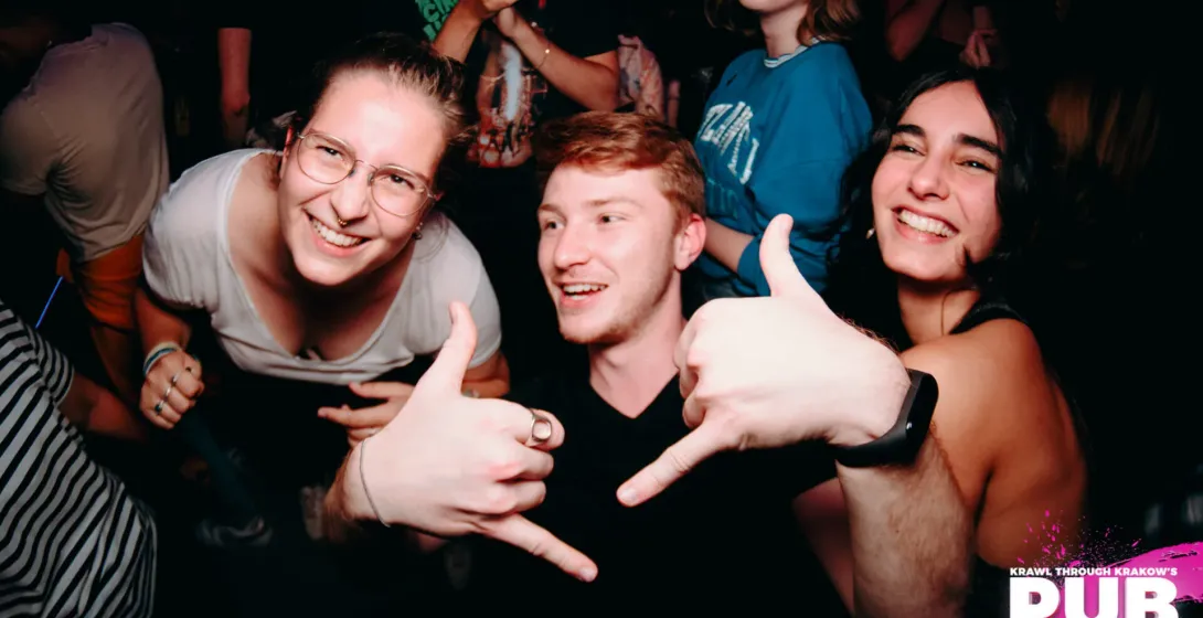 Happy pub crawlers in Krakow, Poland, enjoying the nightlife.