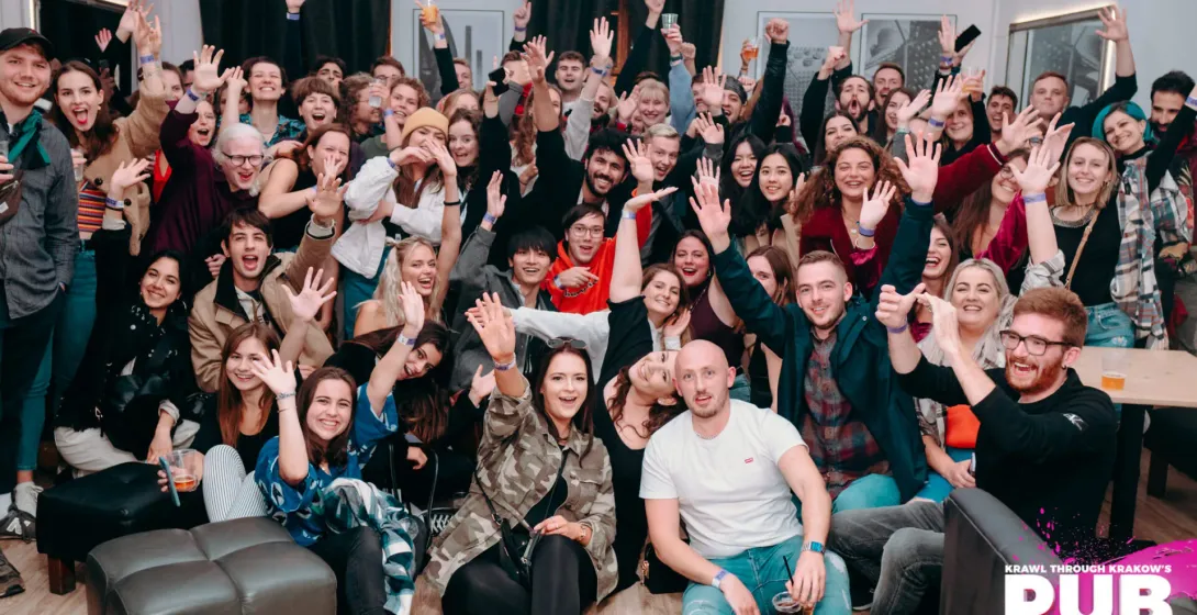 Happy tourists enjoying a pub crawl in Krakow, Poland.