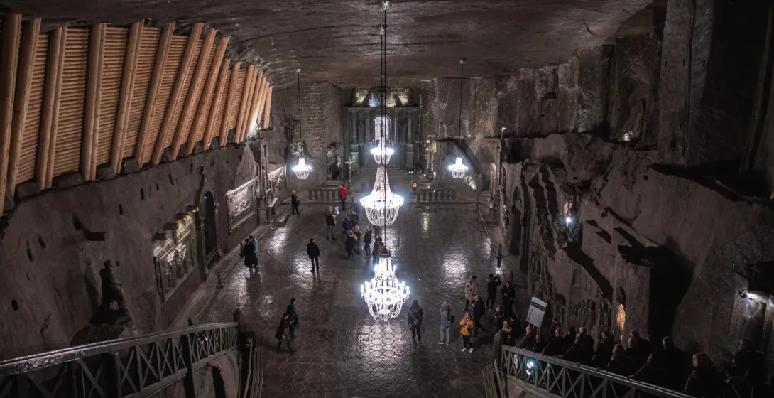 Awe-inspiring view of the Wieliczka Salt Mine's underground chapel, filled with tourists.