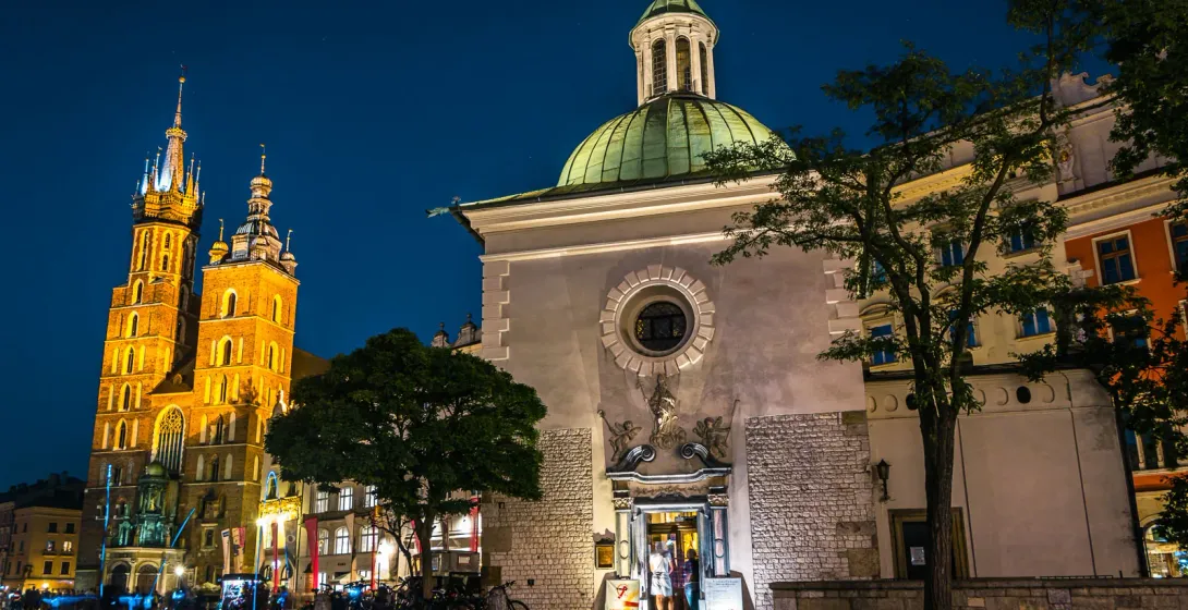 Night view of St. Mary's Basilica and St. Wojciech's Chapel in Krakow's Main Market Square.
